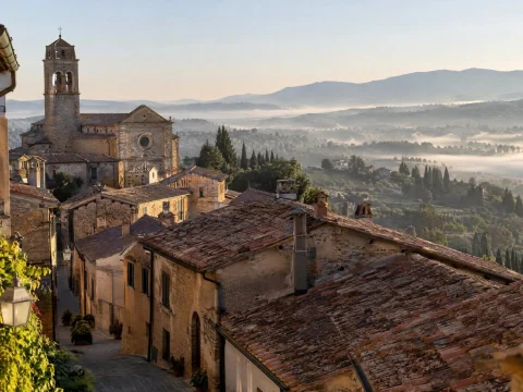 Quiet hilltop town with terracotta roofs and narrow streets in soft morning light